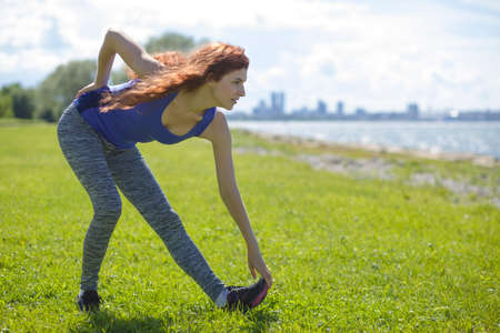 Woman doing yoga at the sea. Beauty fitness womanの写真素材