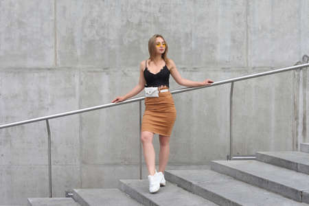 young fashionable girl posing in clothes on the streetの写真素材