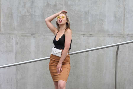 young fashionable girl posing in clothes on the streetの写真素材