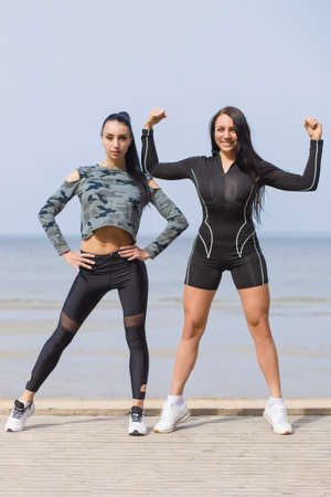 Yoga woman in sportswear relaxing by seaの写真素材