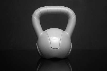 small plastic kettlebell on a black background