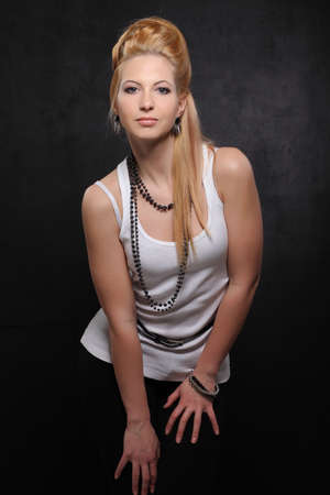 young beautiful woman on black studio backgroundの写真素材