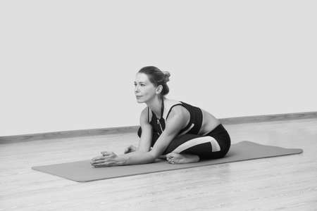 Young woman yoga teacher train in studio