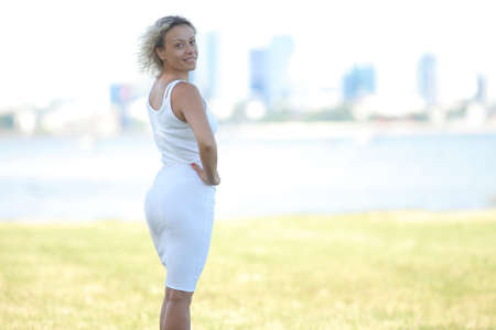 young adult woman in summer clothes by the sea