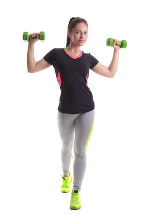 Athletic young woman doing workout with weights on white backgroundの写真素材