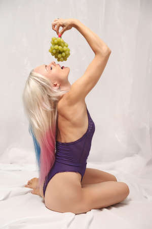 young woman in lingerie on a light backgroundの写真素材