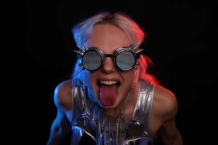 portrait of a young woman with glasses on a dark background