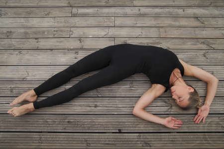 Beautiful young woman doing yoga exercise, Outdoor