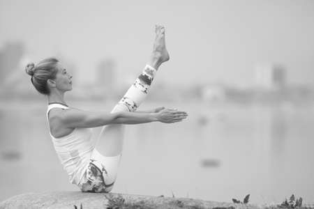 young beauty girl do exercises in summer by the seaの写真素材