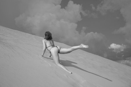 young sporty woman in a swimsuit on the sandの写真素材