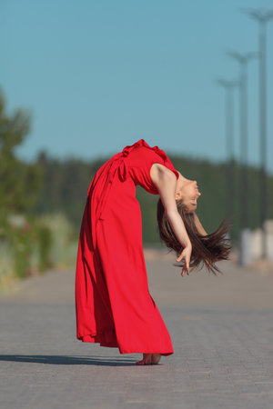 young beaty flexible asian woman in red dressの写真素材