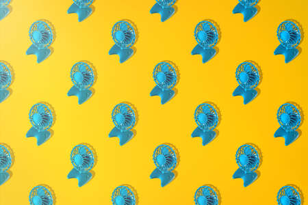 Colorful background with fan in yellow and blue colors. Minimalistic summer concept.の写真素材