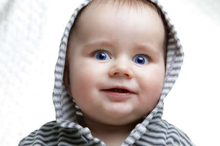 head shoot of cute baby with blue eyes and nice smile