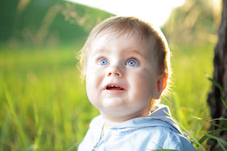 portrait of happy looking little boy with blue eyesの写真素材