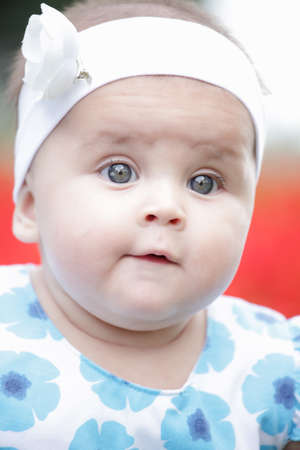 cute baby-girl outdoors clouse up headshoot