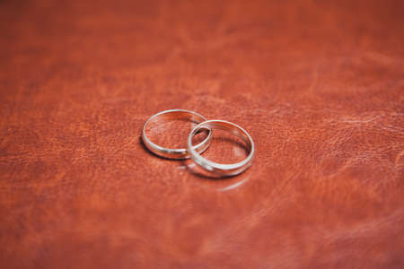 closeup of two gold rings on latherの写真素材
