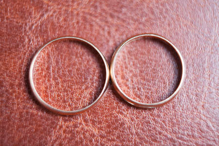 closeup of two gold rings on latherの写真素材