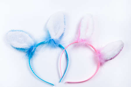 pink and blue Bunny Ears in white backgroundの写真素材