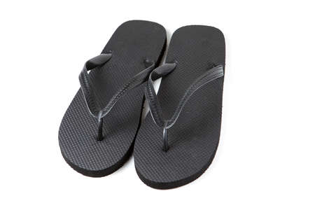 Black flip-flops isolated against a white backgroundの写真素材