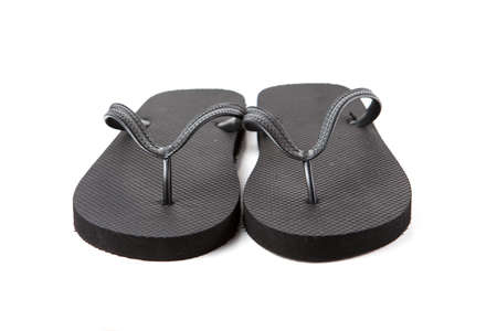 Black flip-flops isolated against a white backgroundの写真素材
