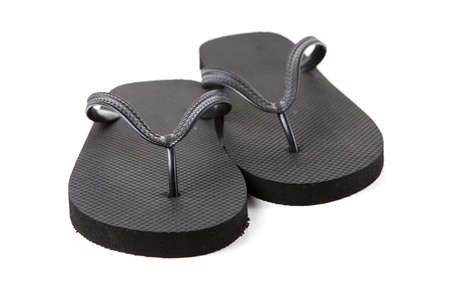Black flip-flops isolated against a white backgroundの写真素材
