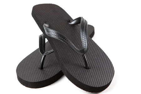 Black flip-flops isolated against a white backgroundの写真素材