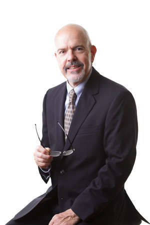 businessman in dark blue suit, holding glasses  isolated on white backgroundの写真素材