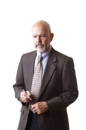 businessman in suit holding pen and thinking isolated on white backgroundの写真素材