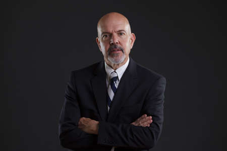 businessman in dark blue suit looking seriousの写真素材