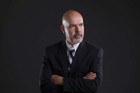 businessman in dark blue suit looking seriousの写真素材