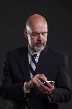 businessman in suit holding smartphoneの写真素材