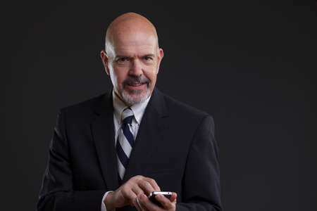 businessman in suit holding smartphoneの写真素材