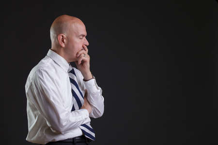 Businessman in white shirt and big strip tie looking desperateの写真素材