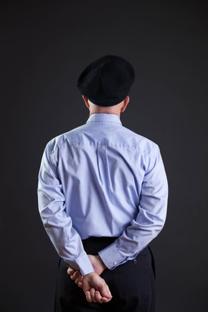 gentleman in shirt and beret shot fron backの写真素材