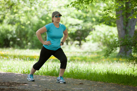Young woman stretching in the parkの写真素材