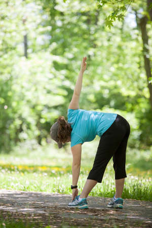 Young woman stretching in the parkの写真素材