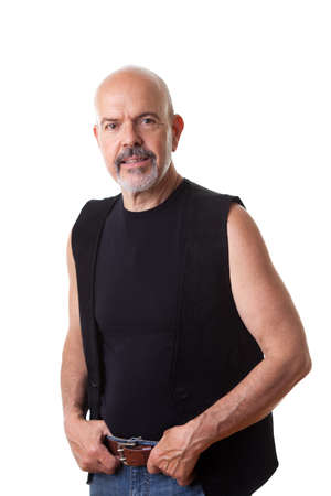 Mature biker holding hands on his belt, smiling, isolated on whiteの写真素材