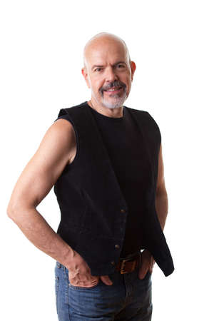 Mature biker holding hands in his pokets, smiling, isolated on whiteの写真素材