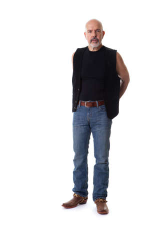 Mature biker holding hands behind the back, serious look, isolated on whiteの写真素材