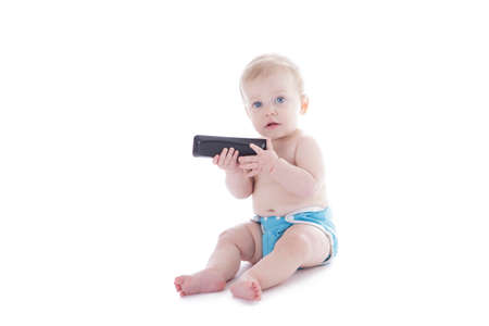 baby in cloth diaper holding tv remote isolated on whiteの写真素材