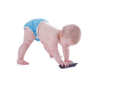 baby in cloth diaper holding tv remote isolated on whiteの写真素材