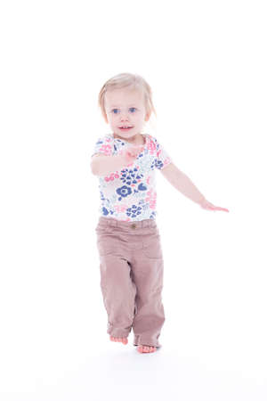 toddler girl dancing barefoot, isolated on whiteの写真素材