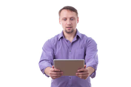 Man holding a tablet, funny expression, isolated on whiteの写真素材