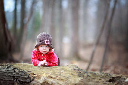 happy little child, baby girl laughing and playing in the fall outdoorsの写真素材