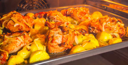 Oven Baked Chicken and Potatoes onion crust, golden, wings, thighs, tasty, appetizing, beneficial, rich in calories, oven 200 degrees recipe food heatの写真素材