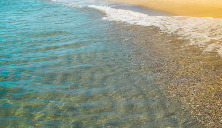 Soft wave of blue ocean on sandy beach. Background.の写真素材