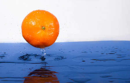 Tangerine with water splash fresh, wet, clear tropicalの写真素材