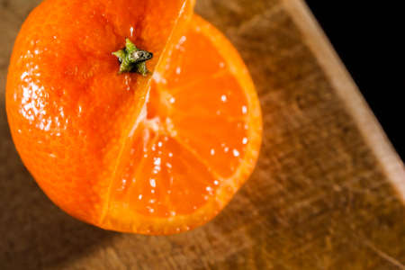 Mandarin orange on a black background juicy cut foodの写真素材