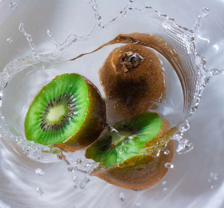 Fresh kiwi splash in water to movement with bubblesの写真素材