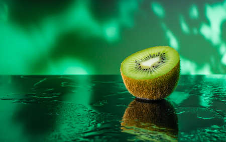 Fresh kiwi fruit splashing in the waterの写真素材